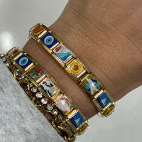 THE WORLD IS YOURS CHARM BRACELET